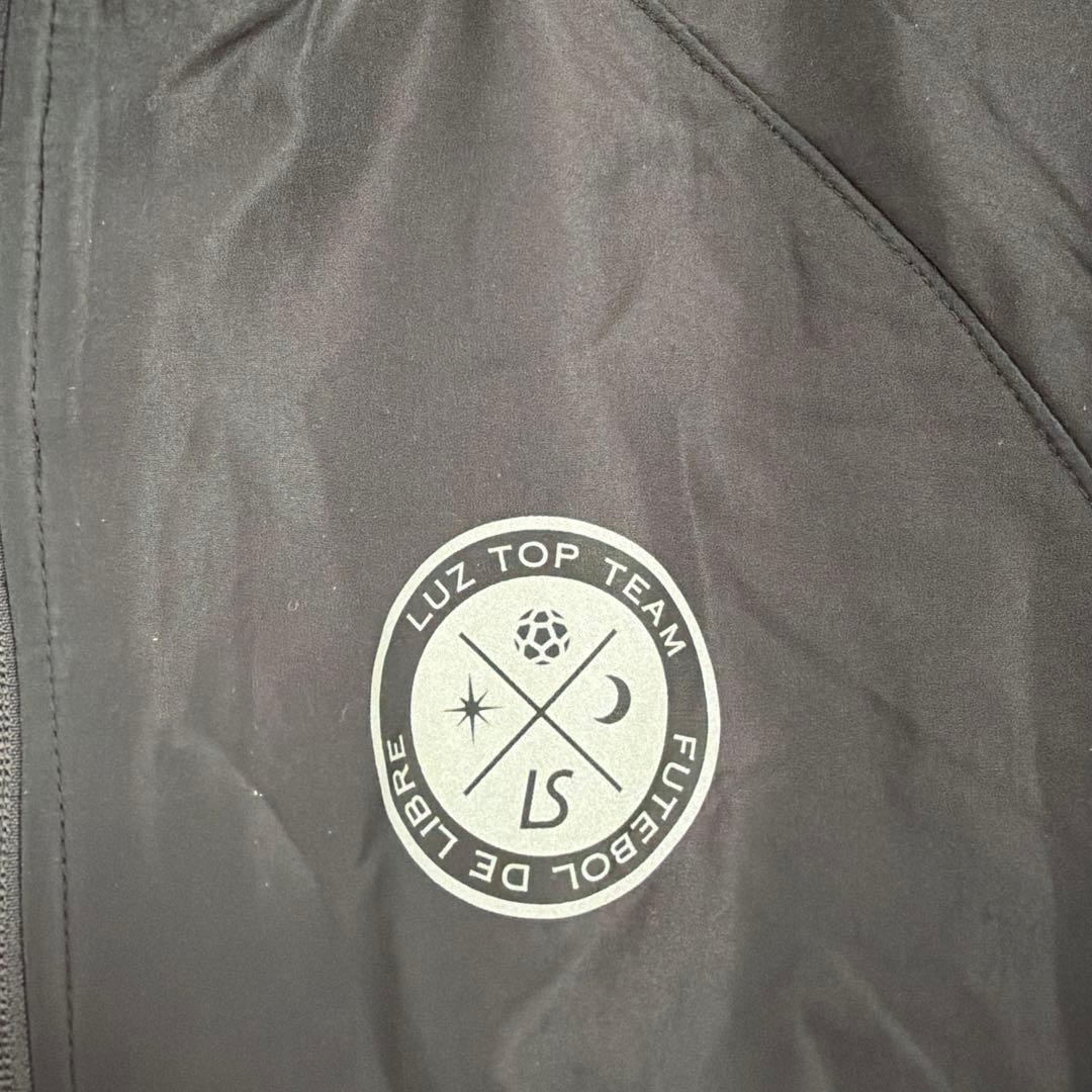 LS ブラックノーカラージャケット Luz Top Team