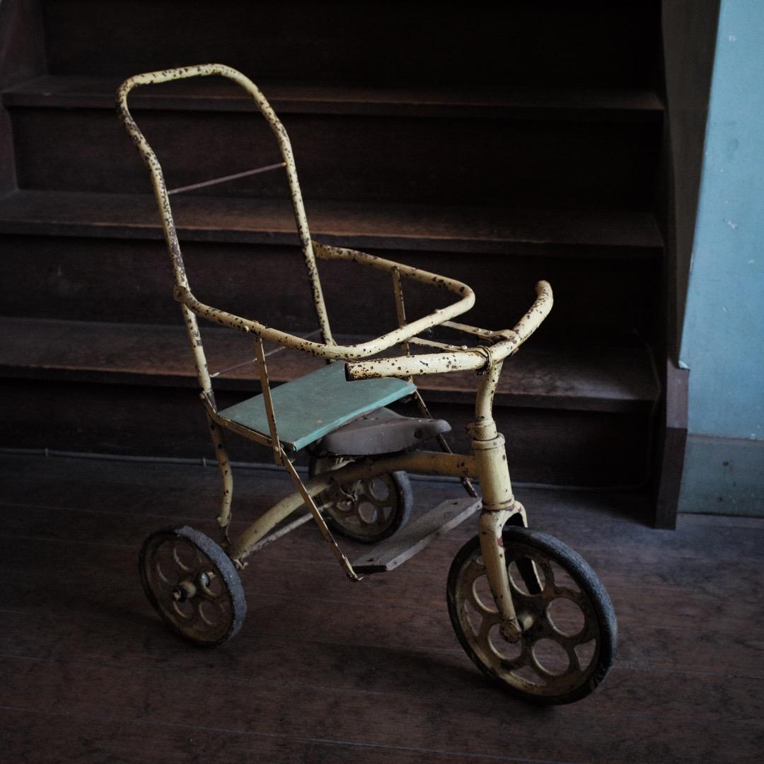 古いペンキ塗りの鉄製手押し三輪車 / 昭和時代