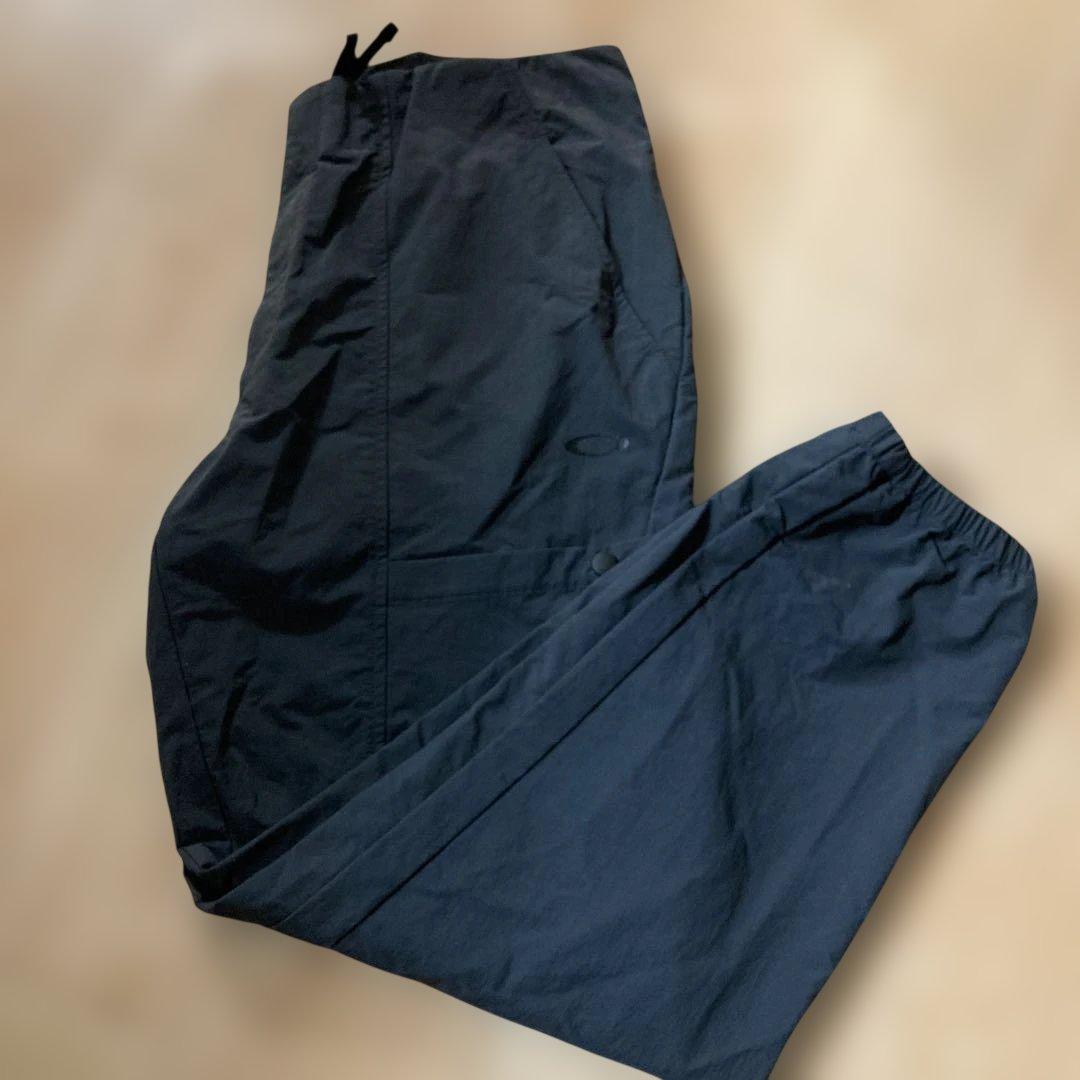 新品未使用タグ付きOAKLEYマットチャコールグレーピステウィンドブレーカーXL