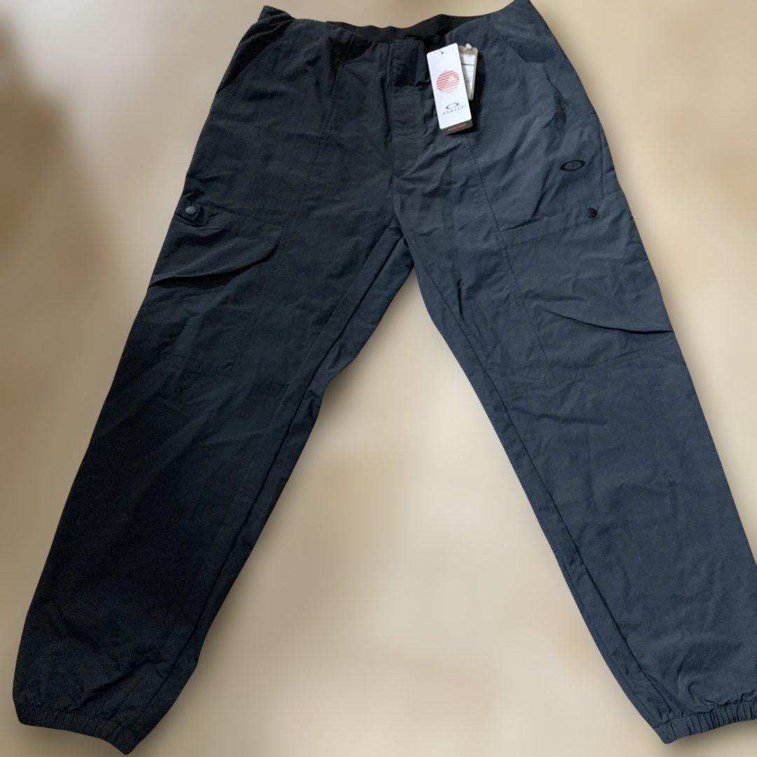 新品未使用タグ付きOAKLEYマットチャコールグレーピステウィンドブレーカーXL